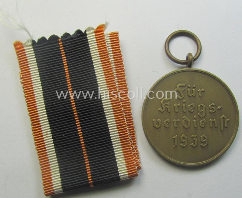 'Kriegsverdienstmedaille 1939' being a non-maker-marked- (and/or: typical 'Buntmetall'-based) specimen that came together with its full-length (and orange-red-coloured!) ribbon (ie. 'Bandabschnitt')