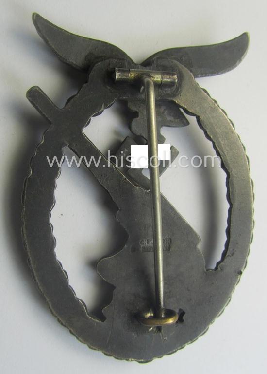 WH (Luftwaffe) 'Flakkampfabzeichen' being a detailed 'Buntmetall'-based and clearly maker-marked example as was produced by the: 'C.E. Juncker'-company and that comes as moderately worn
