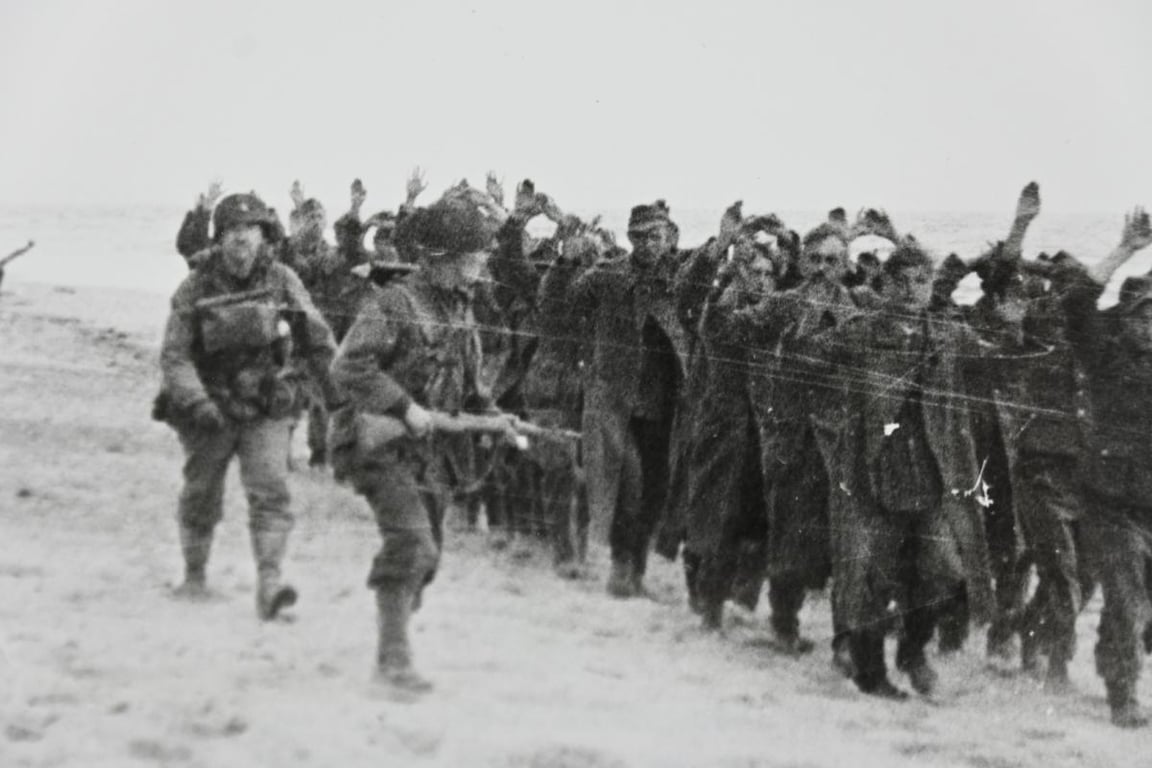 US WW2 Press Photo 'Prisoners of War on the Normandy Beach'