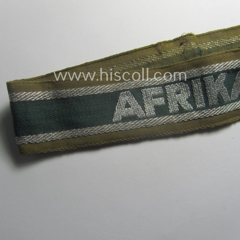 Minimally worn, 'BeVo'-like cuff-title (ie. 'Ärmelstreifen') entitled: 'Afrikakorps' being a with certainty issued example that comes in an overall very nice- (ie. non-shortened- and/or once tunic-attached-), condition