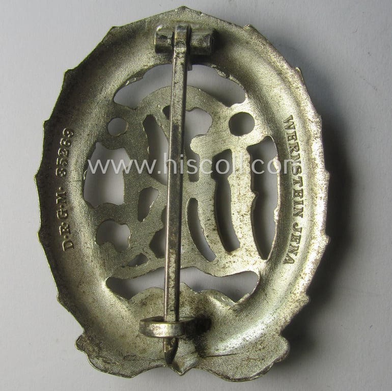 'Reichssportabzeichen DRL in Silber' (or: DRL sports'-badge in silver) being a just moderately worn- ie. used example that is nicely maker- (ie. 'Wernstein - Jena'-) marked on its back