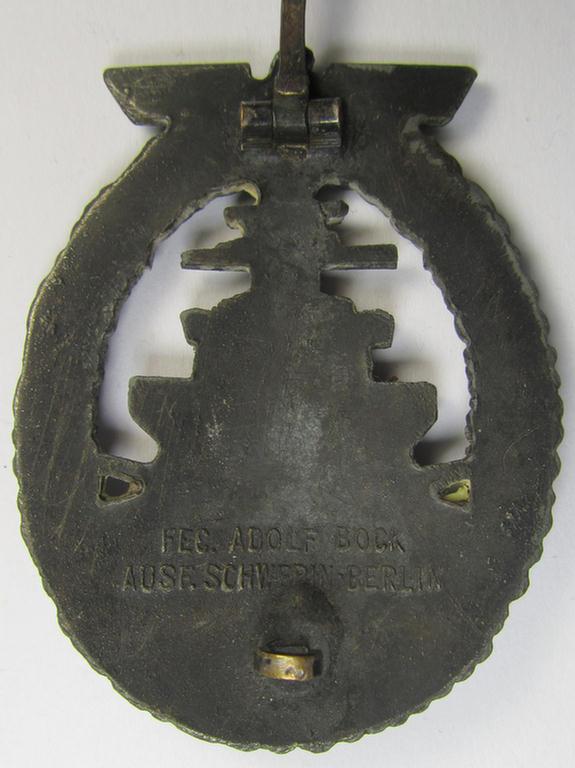 WH (Kriegsmarine) 'Flottenkriegsabzeichen' (or: high-sea fleet badge) being a typical zinc- (ie. 'Feinzink'-) based and/or (I deem) later-war-period version that is neatly maker- (ie. 'Fec. Adolf Bock') marked on its back