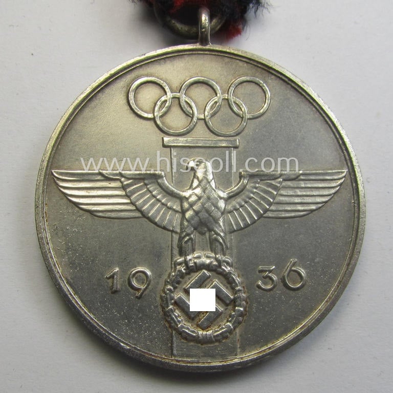 'Deutsche Olympia-Erinnerungsmedaille 1936' being a non-maker-marked example that comes mounted onto its original ribbon (ie. 'Bandabschnitt')