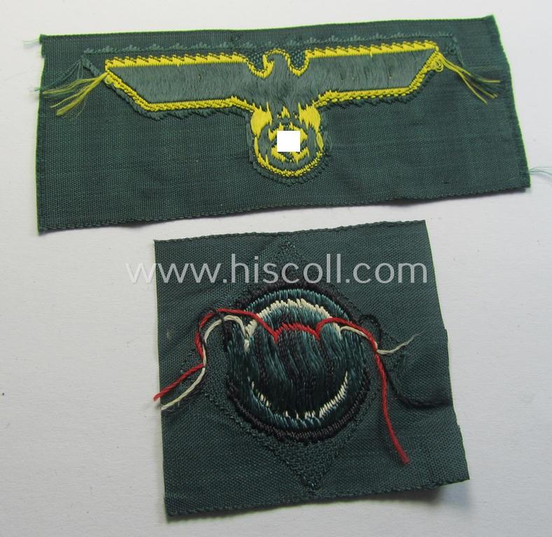Neat, WH (KM ie. 'Küsten-Marine o. Marine-Artillerie') side-cap-eagle and cocarde-set (being a 'virtually mint- ie. unissued' set as executed in golden-yellow-coloured linnen on a darker-green-coloured background)