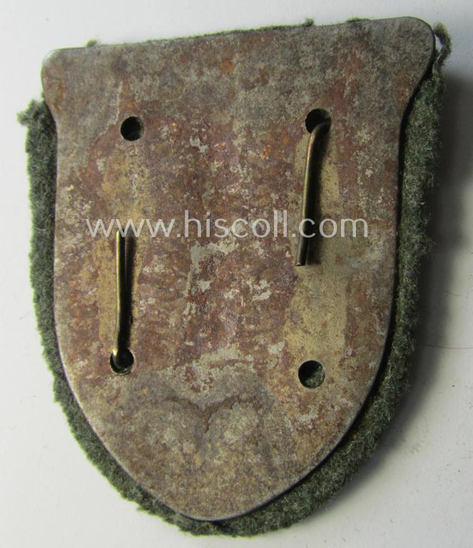 Truly worn, WH (Heeres o. Waffen-SS) 'Krim'-campaign-shield that comes mounted onto its original, field-grey-coloured 'backing' and that comes in a surely issued-, worn and/or carefully tunic-removed-, condition