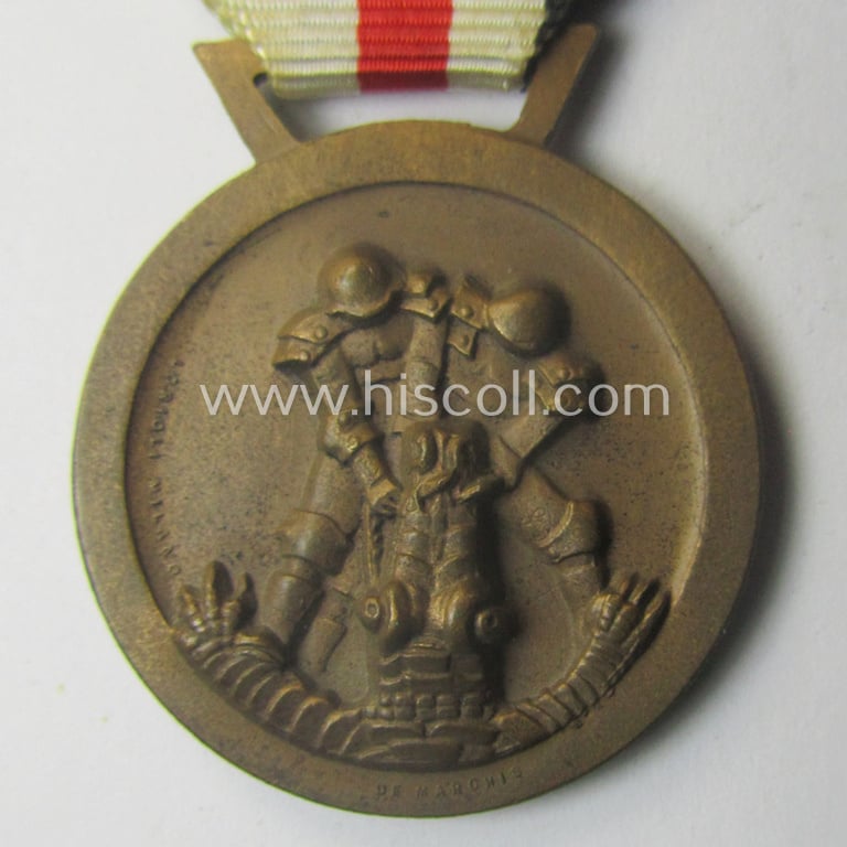 Golden-bronze-coloured- (and I deem 'Buntmetall'-based-) example of a: 'Deutsch-Italienische Feldzugsmedaille' (or: German-Italian campaign-medal) that comes mounted onto its (regular-sized) piece of original (and somewhat faded!) ribbon