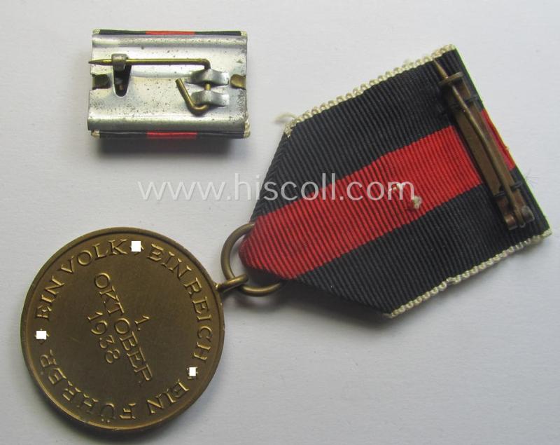 WH Czech-occupation- (ie. 'Anschluss'-) medal: '1. Oktober 1938' that comes mounted onto its period ribbon and that shows a firmly (and period!) attached 'Prager Burg-Spange' and that came with its accompanying 'Feld-/Bandspange'