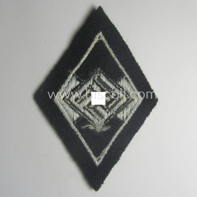 Waffen-SS-pattern, machine-embroidered and/or black- and white-coloured sleeve-insignia (ie. 'Ärmelraute') depicting a so-called: 'HJ-Raute' as was used and intended to signify former membership within the 'Hitlerjugend'