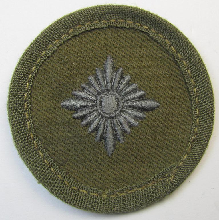 WH (Heeres) 'tropical-pattern', machine-embroidered rank-insignia (ie. roundel) being a neatly maker- (ie. '..u. S.'-) marked example, as was executed in greyish-blue-coloured linnen as was intended for an: 'Oberschütze'