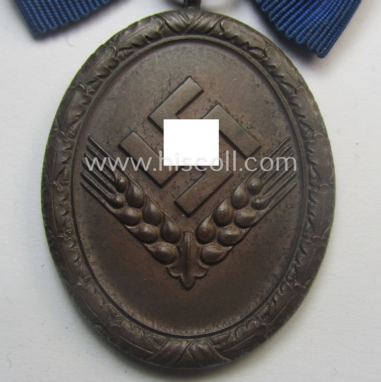 Scarcely encountered example of a: 'Reichsarbeitsdienst der weiblichen Jugend' (or: RADwJ) so-called: 'Dienstauszeichnung der 4. Stf. in Bronze' that comes mounted onto its period ('bow-tie'-shaped) ribbon (ie. 'Bandabschnitt')