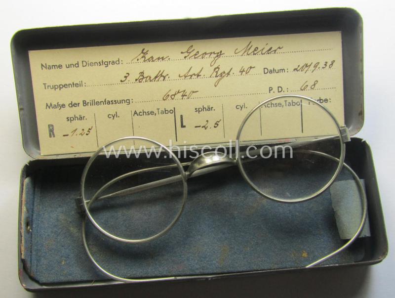 Complete pair of 'standard-issued'-pattern, WH-service-glasses (ie. 'Dienstbrille') as issued to the: 'Kan. Georg Meier' serving within the: '3. Batt. Art.Rgt. 40' and that comes stored in its period-container