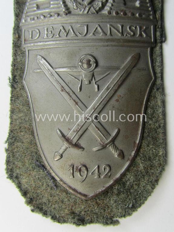 Superb example of a - fairly scarcely encountered! - WH (Heeres ie. Waffen-SS) 'Demjansk'-campaign-shield as executed in typical magnetic metal (ie. so-called: 'Eisenblech') and that comes in an overall very nice- ie. fully untouched, condition