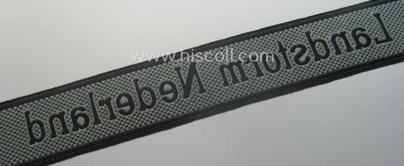 Waffen-SS, 1943/44 pattern cuff-title (ie. 'Ärmelstreifen') depicting the machine-woven Latin script text in silver-grey linnen as was intended for a member of the: '34. SS-Freiwilligen-Grenadier-Division': “Landstorm Nederland”