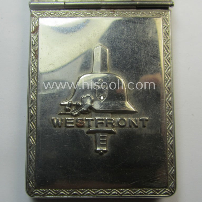 Interesting, WWII-period 'souvenir-item' (ie. tiny note-book) showing on its front an illustration of a steel-helmet and upright-positioned sword coupled with the text: 'Westfront'