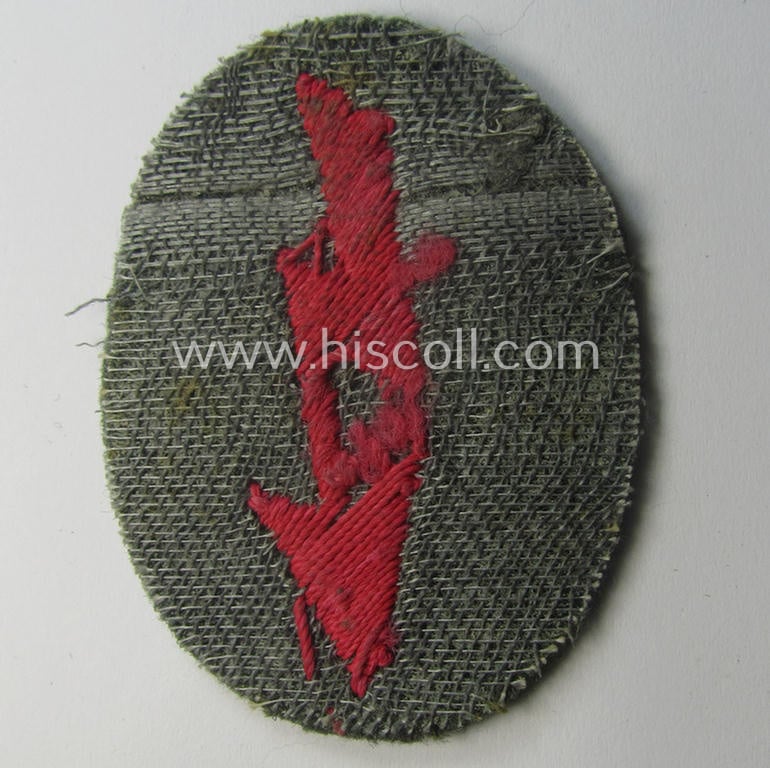WH (Heeres) trade- and/or special-career-insignia ie. hand-embroidered 'signal-blitz' being a hand-embroidered example in pink-coloured linnen on field-grey-coloured wool as was intended for a soldier within the: 'Pz- o. Panzerjäger-Trpn.'
