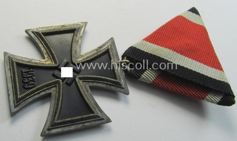 Neat, Iron Cross 2nd class (or: 'EK II. Klasse') being a non-maker-marked example that comes mounted onto its original (Austrian-styled!) ribbon (ie. 'Bandabschnitt') as was (I deem) produced by the (Austrian-based) company named: 'Rudolf Souval...