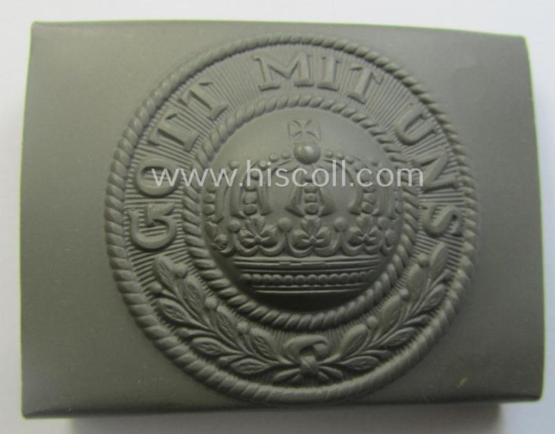 WWI-period field-grey-coloured- and/or steel-based belt-buckle being a (typical) non-maker-marked example that shows the motto: 'Gott mit Uns' and came still packed into its period piece of thin-shaped 'wrapping-paper'