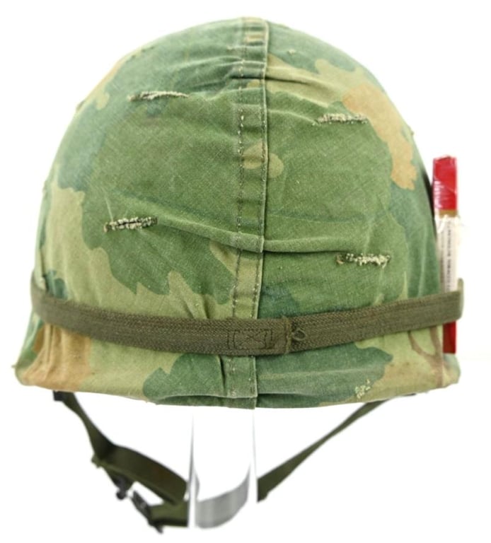 US Vietnam War Infantry helmet with camouflage cover and attached content