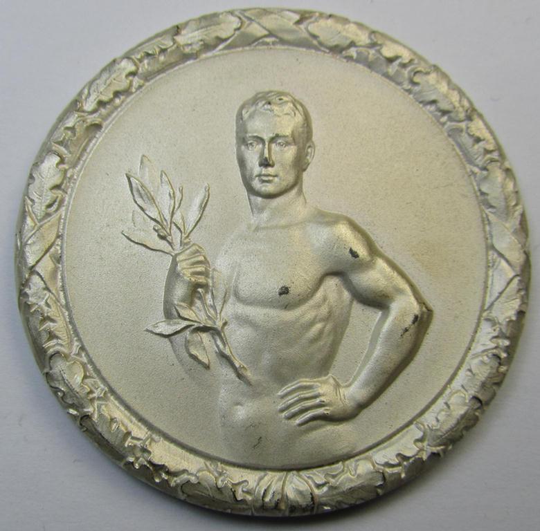 Interesting, D.D.A.C.-related, commemorative plaque (ie. 'Erinnerungs- o. nichttragbare Auszeichnungsplakette') showing an illustration of a sportsman and on its back the text: 'II. Preis Dreikampf Männer 1938' and that comes stored in its period...