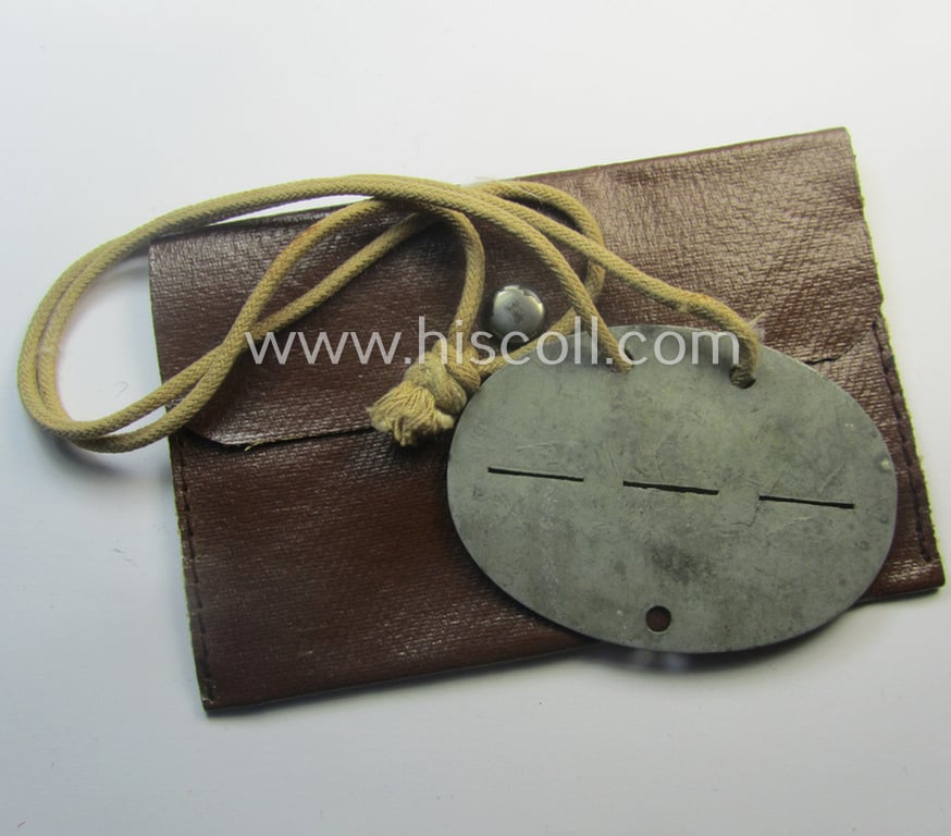 Zinc-based, WH (Heeres-) transport (ie. 'Nachshub'-) related ID-disc bearing the clearly stamped unit-designation: 'Stammkomp/Kf.Ers.Abt. 17' and that comes stored in its period-pouch as issued and/or worn