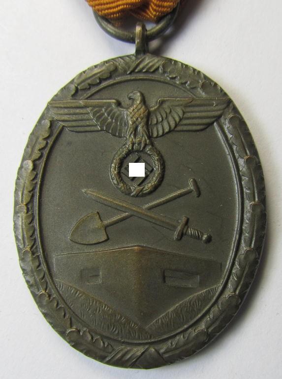 Medal-set: 'Deutsches Schutzwall Ehrenzeichen' (aka: 'Westwall'-medal) being a non-maker-marked- and/or: 'Buntmetall'-based specimen that comes mounted onto its period- (and neatly folded ie. pre-confectioned) ribbon (ie. 'Bandabschnitt')