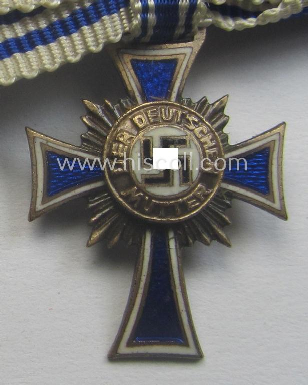 Miniature of an: 'Ehrenkreuz der deutschen Mutter - zweite Stufe' (or: silver-class mothers'-cross) being a non-maker-marked example that comes in an overall nice- (albeit moderately worn- ie. used-), condition