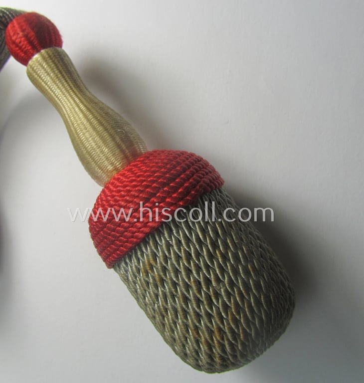 Bright-white-, red- and/or silver-coloured, EM- (ie. NCO-) type side-arm knot (ie. 'Portepee' ie.: 'Troddel') as was used for the various WH-bayonets and that comes in an overall very nice- (ie. 'virtually mint- ie. unissued'-), condition