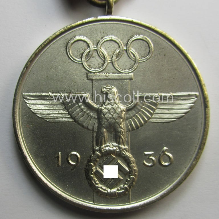 'Deutsche Olympia-Erinnerungsmedaille 1936' being a non-maker-marked example that comes mounted onto its original ribbon (ie. 'Bandabschnitt')