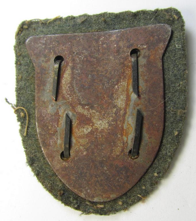 Attractive, WH (Heeres o. Waffen-SS) 'Krim'-campaign-shield that comes mounted onto its original, field-grey-coloured 'backing' and that comes in an issued-, moderately worn and/or carefully tunic-removed-, condition