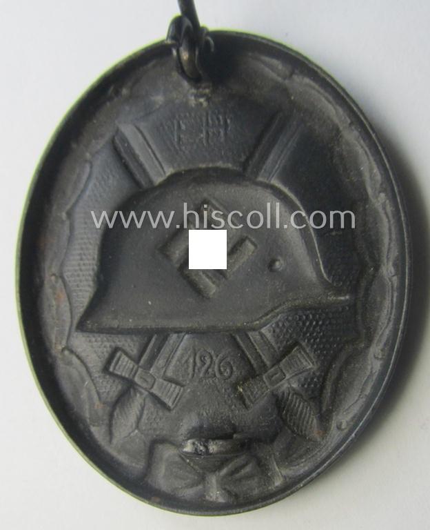 Dual-maker- (ie. 'E.H.'- and/or: '126'-) marked example of a black-class wound-badge (or: 'Verwundeten-Abzeichen in Schwarz') being an example that was produced by the maker (ie. 'Hersteller') named: 'Eduard Hahn'