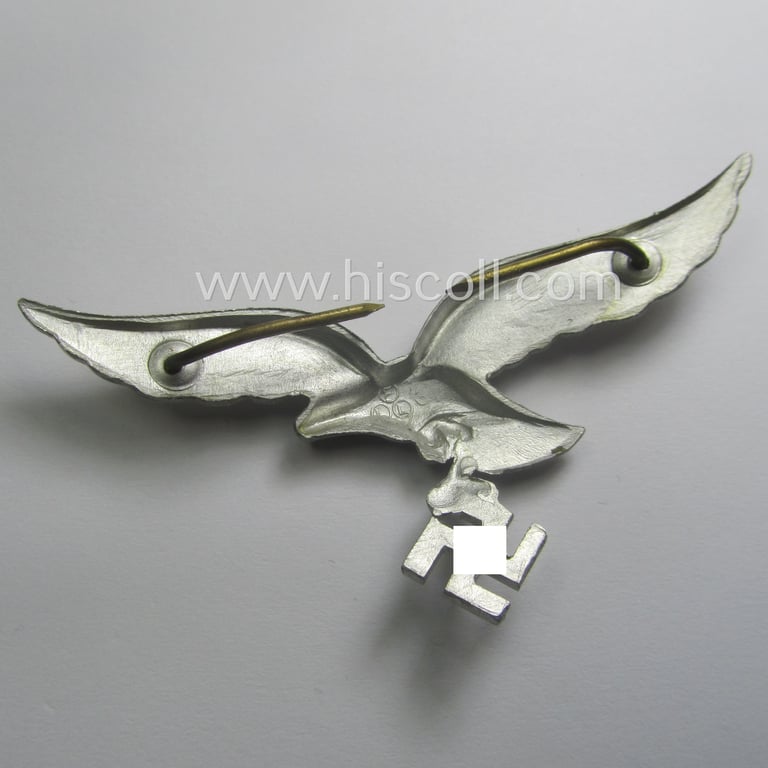 Minimally worn, WH (Luftwaffe) EM/NCO-pattern visor- (ie. 'Schirmmützen'-) cap-eagle being a maker- (ie. 'F.L.L.'-) marked example as executed in aluminium based metal