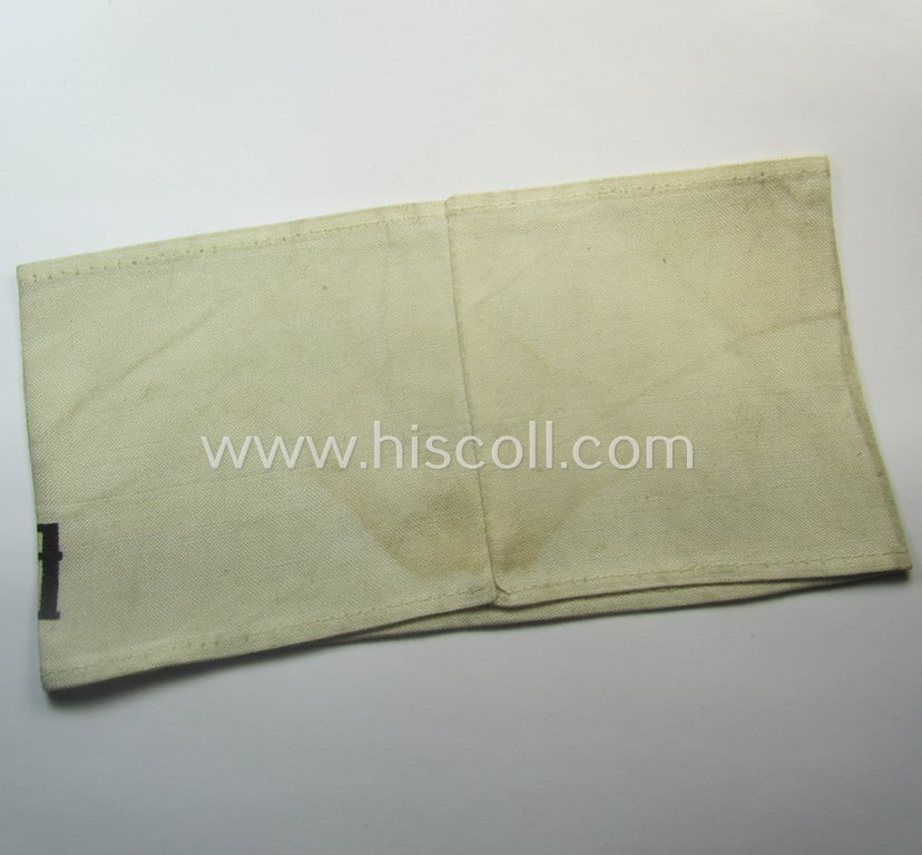 Linnen-based- and/or neatly printed, white-coloured armband (ie. 'Armbinde') entitled: 'Im Dienst der Deutsche Wehrmacht' as was intended for (civilian) staff-members serving within the German armed forces ie. 'Deutsche Wehrmacht'