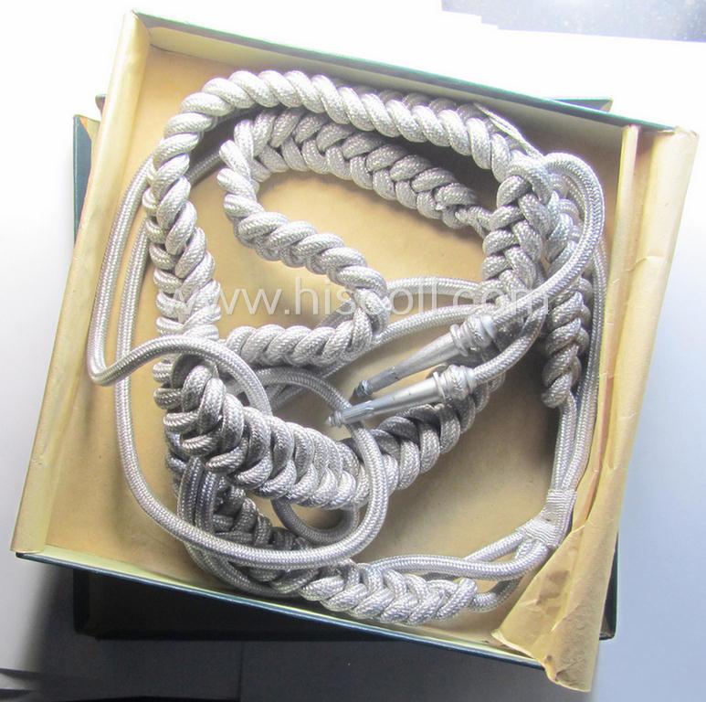 Bright-silver-toned, WH (Heeres): 'Paradefangschnur für Adjutanten' (ie. adjutants'-aiguillette) that comes stored in its period, carton box as issued