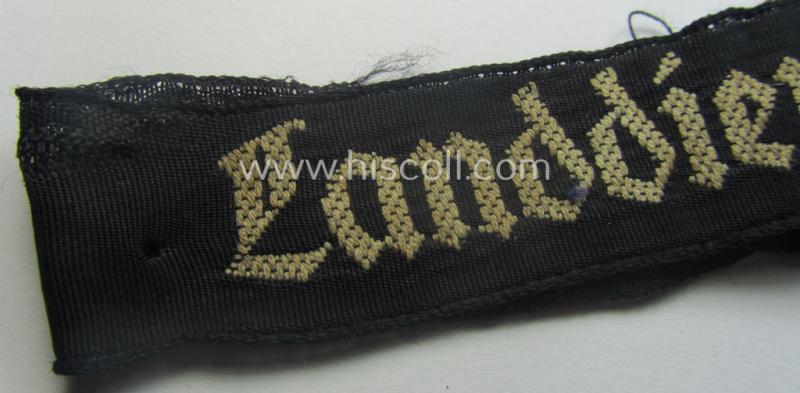 Truly worn (ie. relic) example) of the - actually scarcely encountered! - HJ ('Hitlerjugend') armband (ie. cuff-title) as woven in the neat 'BeVo'-like-pattern, entitled: 'Landdienst der HJ'