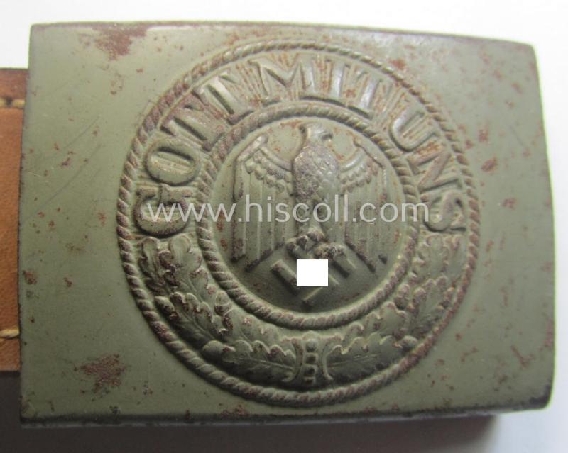 Minimally used, WH (Heeres) field-grey-coloured- and/or steel-based belt-buckle being a clearly maker-marked example that comes mounted onto its maker- (ie. 'Schmöle & Comp - Menden'-) marked and/or '1941'-dated leather-based tab