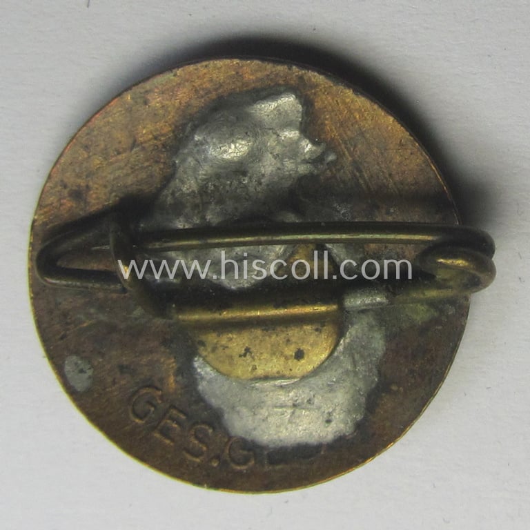 Smaller-sized- and early-period, bright-red-coloured 'N.S.D.A.P.'-membership-pin- ie. party-badge (or: 'Parteiabzeichen') that shows a so-called: 'Ges.Gesch.'-patent-pending-designation