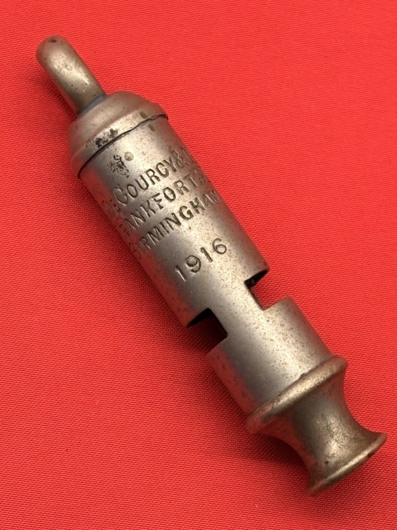 TWO AUTHENTIC ORIGINAL BRITISH OFFICERS WWI 1916 TRENCH WHISTLES AND LANYARD.