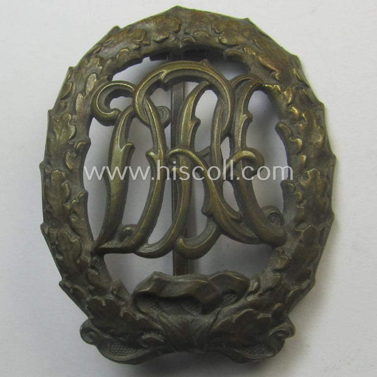 'Reichssportabzeichen DRL in Bronze' by: 'Wernstein' that came stored in its (unusally seen!) red-coloured (and maker- ie. 'Preussische Staatsmünze - Berlin'-marked pouch as issued and found