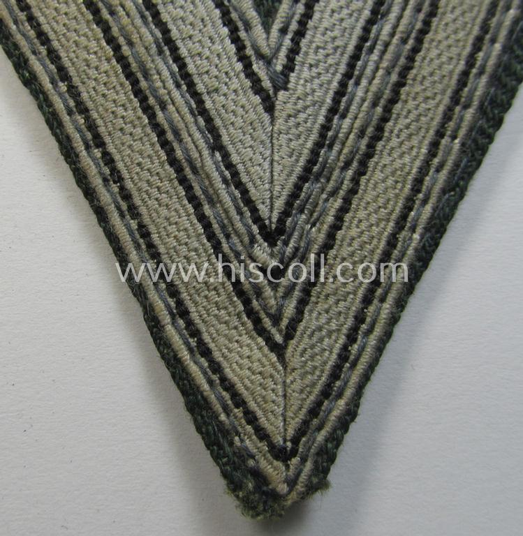 WH (Heeres) 'Armwinkel' (or: arm-chevron) as executed on typical field-grey-coloured wool as was specifically intended for usage by a soldier with the (unusually seen!) rank of: 'Stabsgefreiter'
