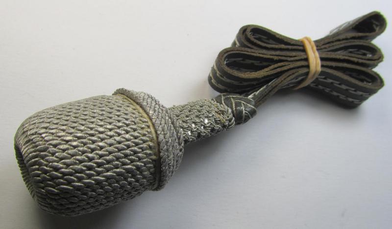 'Standard-issue'-pattern, WH (Heeres) sword-knot (ie. 'Portepee') as executed in green-coloured leather combined with silver-green-coloured 'bullion' and that comes in an overall nice- (ie. I deem just moderately used- ie. worn-), condition