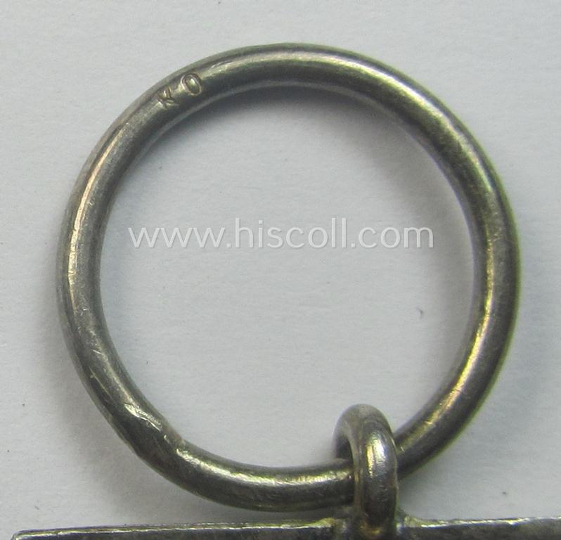 WWI-period: 'Eisernes Kreuz II. Klasse' (or: iron cross second class) being a maker- (ie. 'KO'-) marked example that comes together with its (minimally) confectioned piece of ribbon (ie. 'Bandabschnitt')