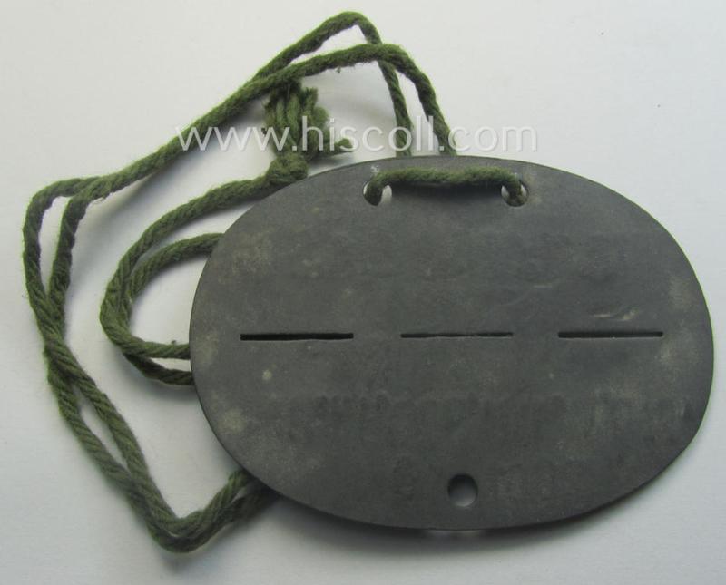 Zinc-based, WH (Heeres) 'Gebirgsjäger'-related ID-disc bearing the clearly stamped unit-designation that reads: 'Stm.Kp.Geb.Fl.E.A.Btl.Mot. 700' and that comes as issued and/or worn