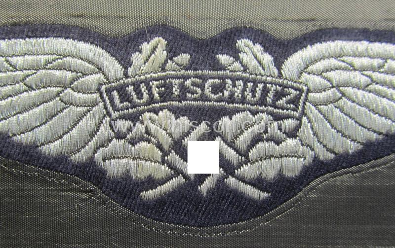 Attractive - and rarely found! - officers'-pattern, so-called: 'Luftschutz' (ie. RLB-) breast-badge (ie. 'Brustabzeichen') as executed in so-called: 'flat-wire', 'BeVo'-weave-pattern and that comes in a 'virtually mint- ie. unissued, condit...