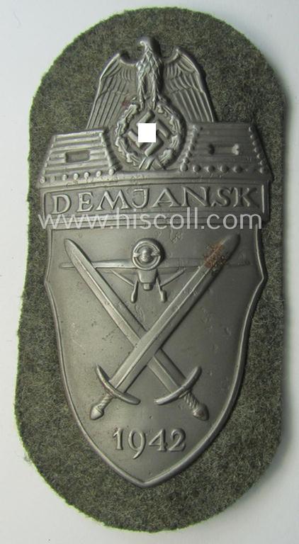 Superb example of a - fairly scarcely encountered! - WH (Heeres ie. Waffen-SS) 'Demjansk'-campaign-shield as executed in typical magnetic, so-called: 'Eisenblech' (and being of the 'missing-log' variant-pattern)