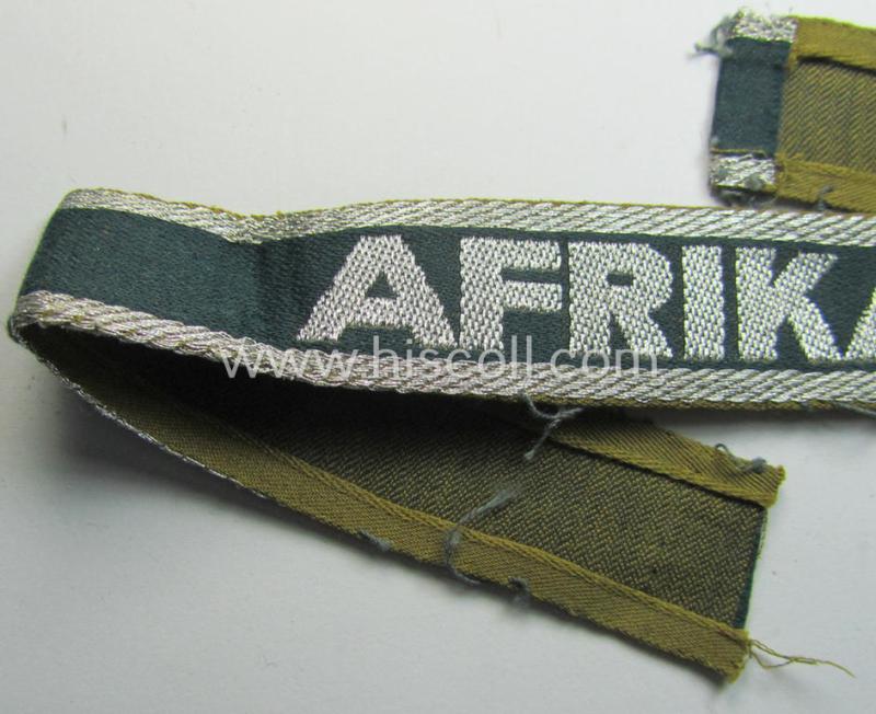 Attractive, 'BeVo'-like cuff-title (ie. 'Ärmelstreifen') entitled: 'Afrikakorps' being a with certainty issued and truly worn example that comes in an overall nice- (ie. hardly shortened- and/or once tunic-attached-), condition