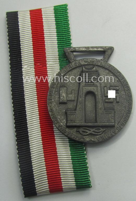 Silverish-bronze-coloured (and zinc-based!) example of a: 'Deutsch-Italienische Feldzugsmedaille' (or: German-Italian campaign-medal) that came together with its (full length- and virtually mint- ie. unissued) piece of original ribbon