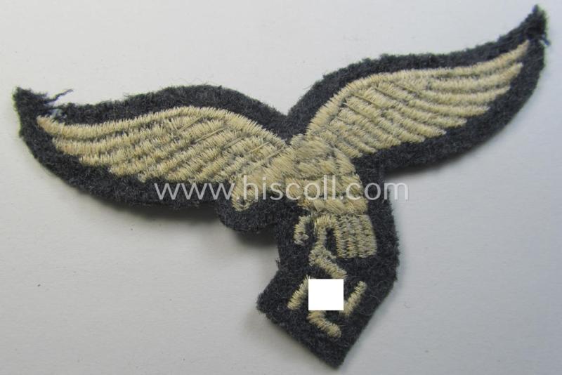 Superb, moderately used- and/or tunic-removed, WH (Luftwaffe) EM- (ie NCO-) pattern, machine-embroidered breast-eagle (showing a 'down-tailed'-eagle and being an early- ie. pre-war-period example) that comes in a moderately used-, condition