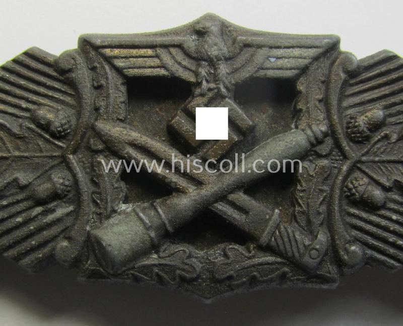 Superb, 'Nahkampfspange in Bronze' (or: bronze-class close-combat clasp ie. CCC) being a neatly maker-marked- and/or minimally converse-shaped specimen as was produced by the: 'JFS'- (ie. 'Joseph Feix u. Söhne'-) company