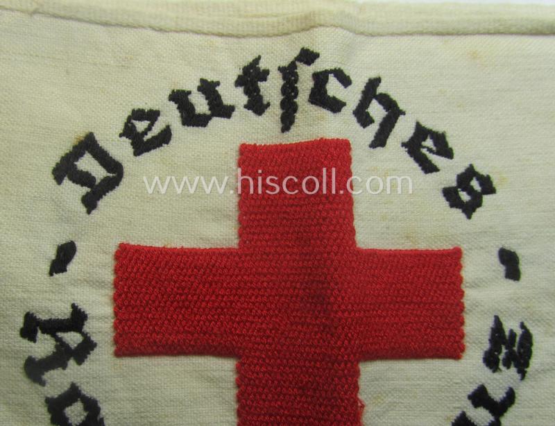 Linnen-based- and/or neatly 'machine-embroidered', beige-white-coloured DRK- (ie. 'Deutsches Rotes Kreuz'-) armband (ie. 'Armbinde') as was intended for the staff-members serving with the: 'Deutsches Rotes Kreuz' (or: German Red Cross)