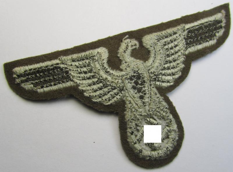 Attractive, machine-embroidered arm-eagle (ie. 'Ärmeladler') as was specifically intended for usage on the brownish-green-coloured tunics of officials of the: 'Reichsministerium für besetzte Ostgebiete' (ie. 'R.M.b.O.')